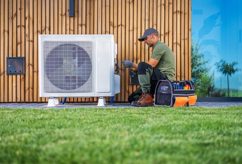 Technician servicing AC unit