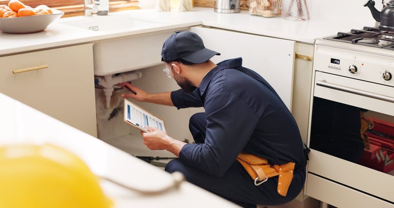 Professional handyman with clipboard during inspection