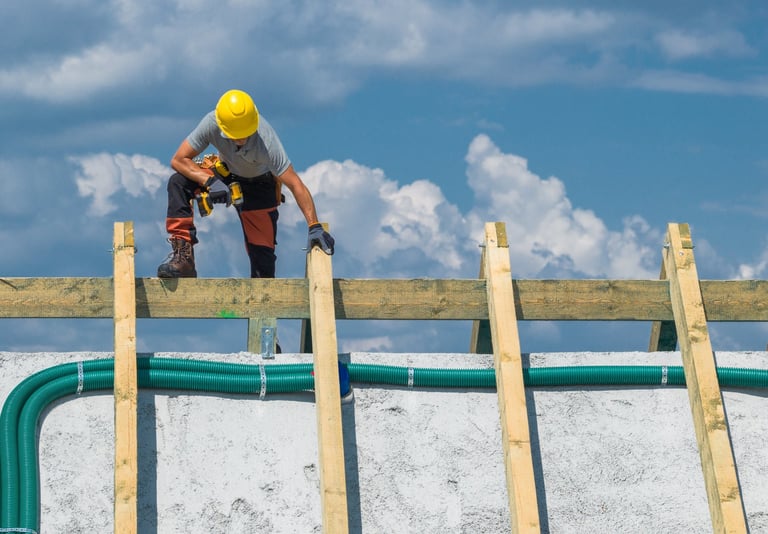 Worker carefully placing wooden beams on a roof structure